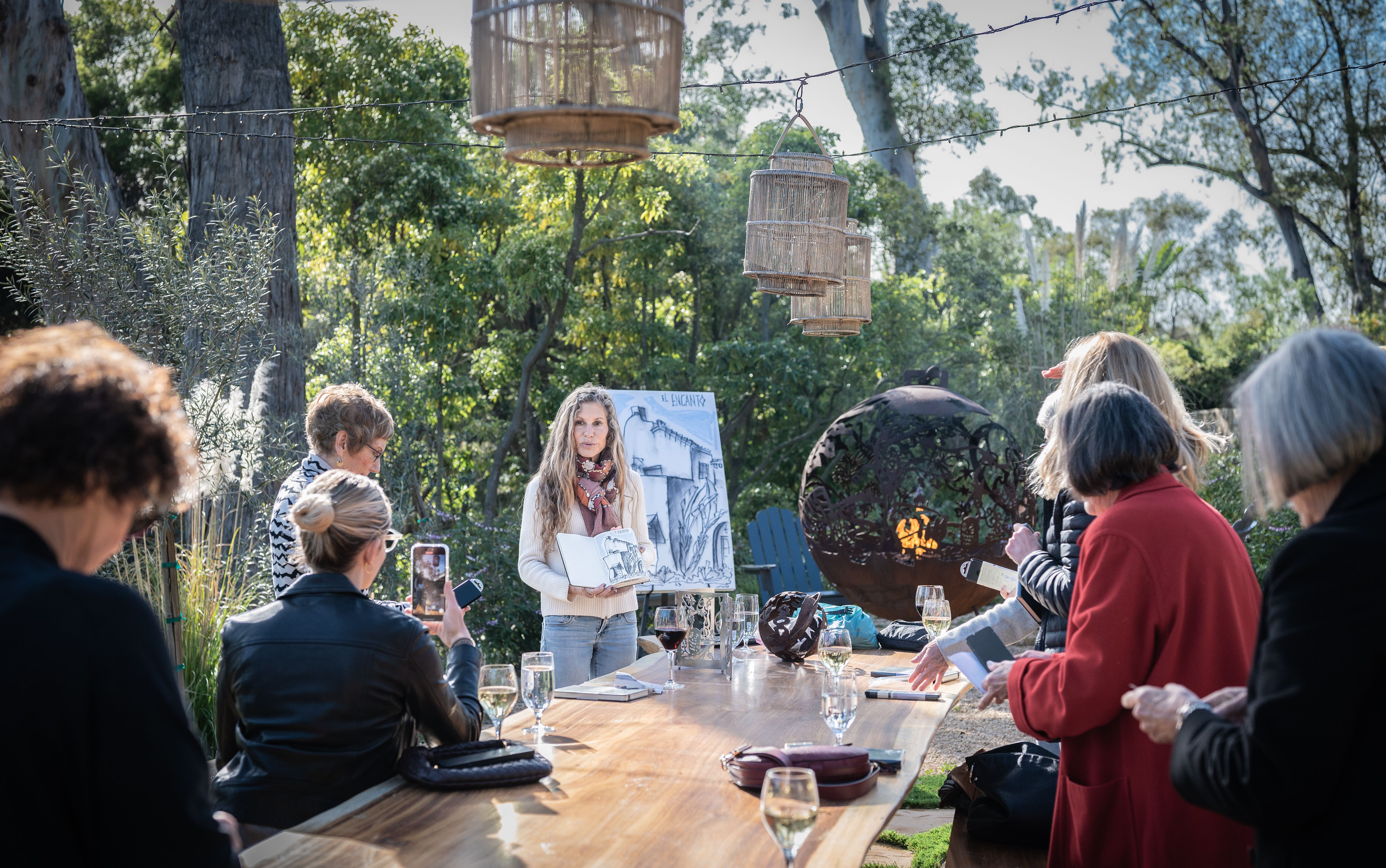 A group of people outside among stately trees as a Santa Barbara artist and architect shares her sketching secrets